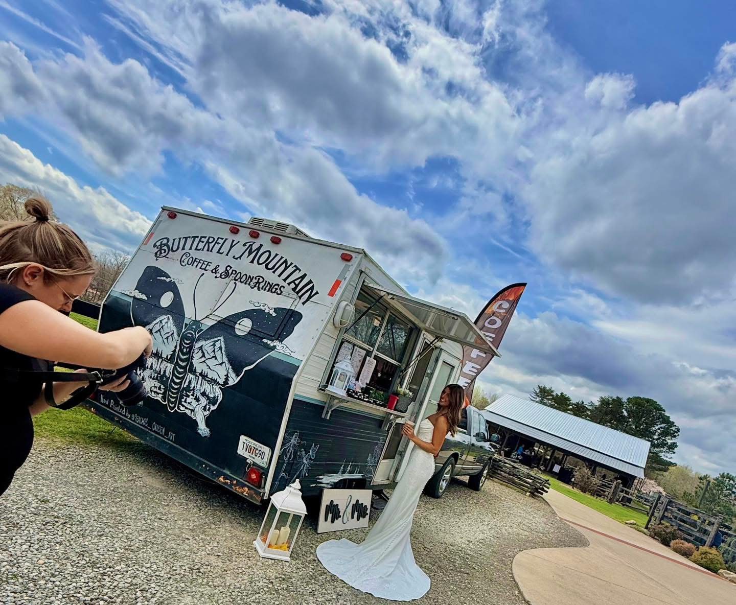 Bride beside Butterfly Mountain Coffee Camper at a wedding venue