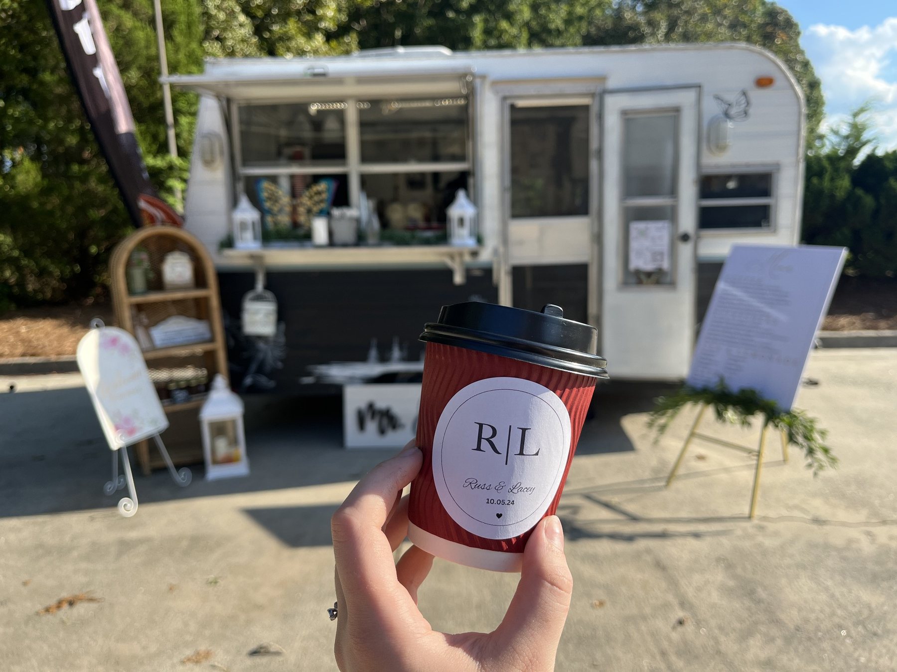 Personalized wedding coffee cup in front of the Butterfly Mountain Coffee Camper