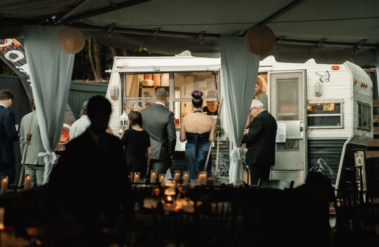 Wedding guests gathered at the coffee camper in the evening